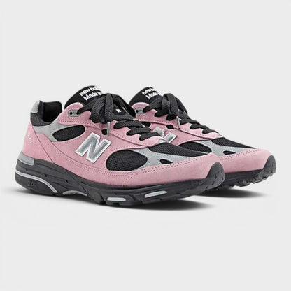 Pink and gray New Balance sneakers, side-by-side view with black laces and 'N' logo