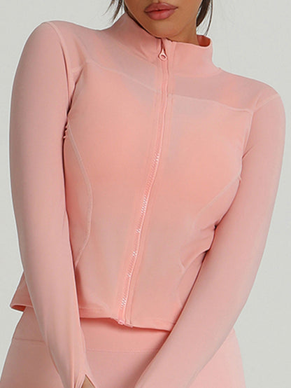 Peach-pink zip-up long-sleeve active top with mesh overlay and thumbholes