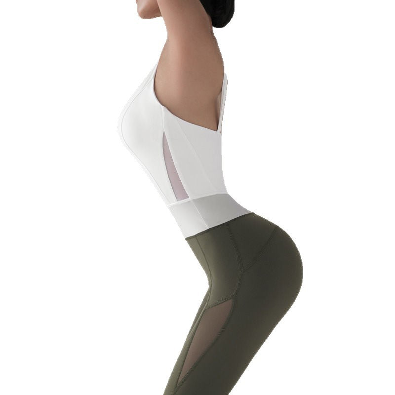 Two-tone one-piece mesh jumpsuit in white and dark green with diagonal cutouts