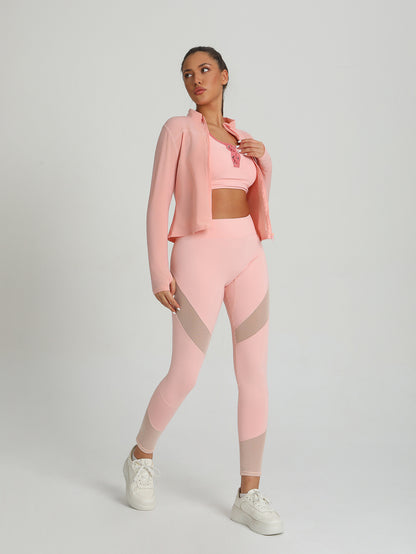Peach-pink activewear set with sports bra, leggings, and open long-sleeve jacket layer