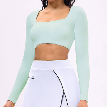 Light blue long-sleeve sports crop top with square neckline and white tennis skirt