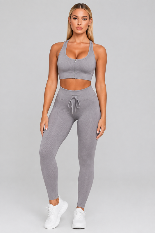 Women's gray zip sports bra and drawstring leggings, front view