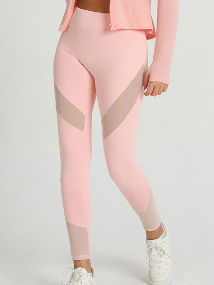 Peach-pink leggings with contrast mesh hip panels and sheer-looking ankle cuffs