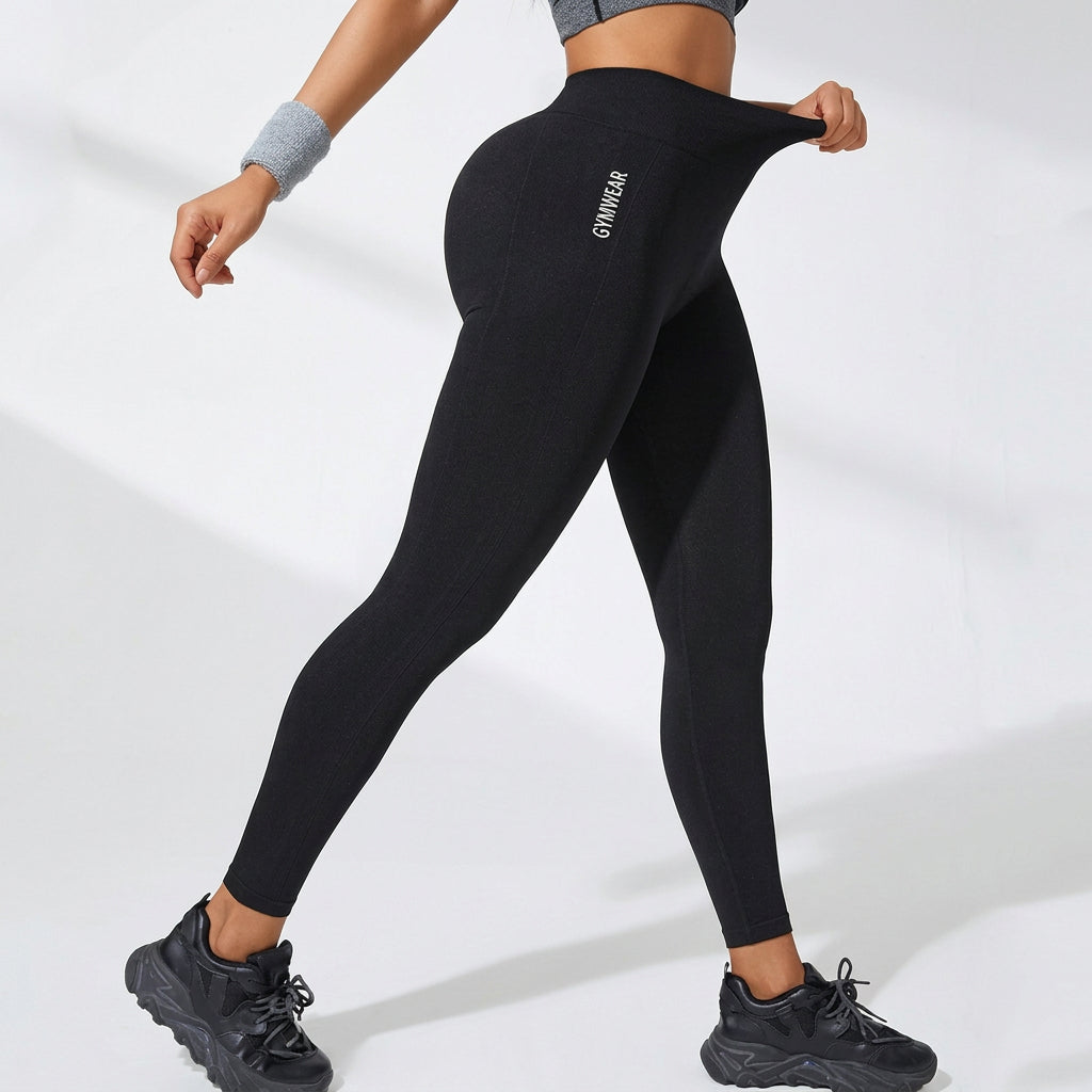 Black high-waisted yoga leggings with slim tapered legs and stitched back detailing