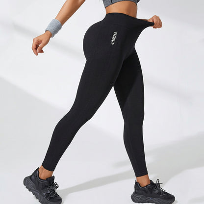 Black high-waisted yoga leggings with slim tapered legs and stitched back detailing