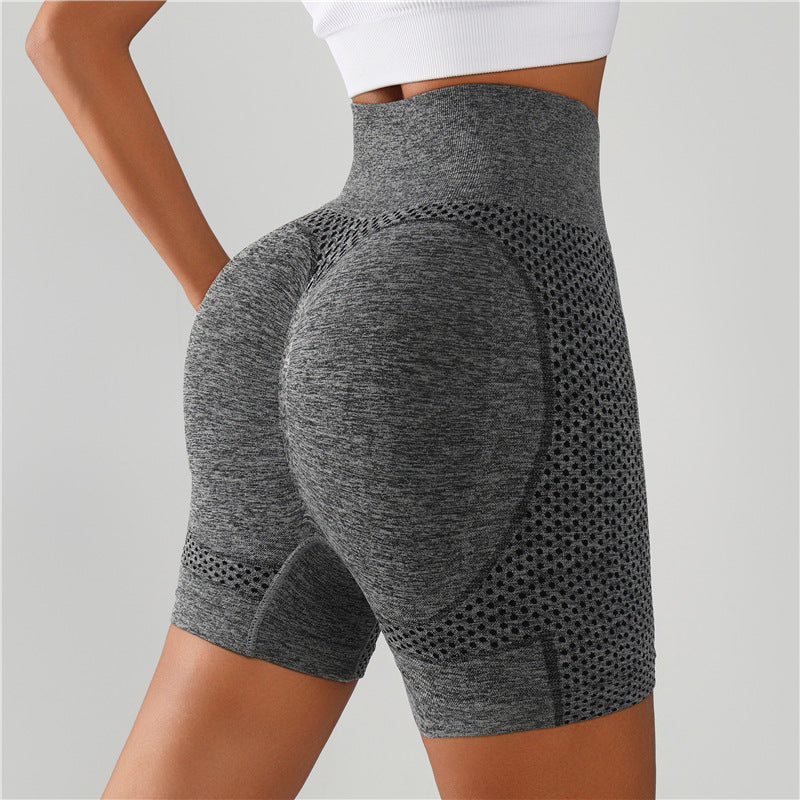 Gray high-waisted gym shorts with textured mesh panels, rear view
