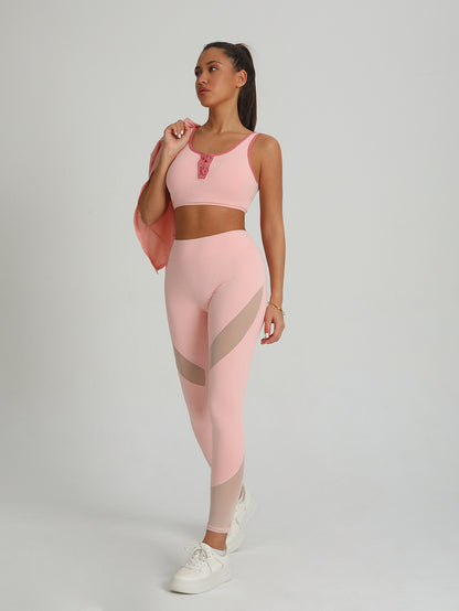 Peach-pink sports bra and leggings set with contrast mesh paneling at hips and thighs