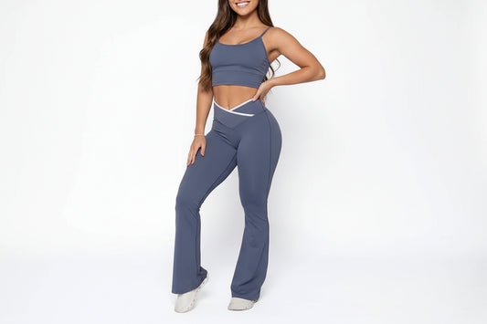 Woman wearing a gray athletic outfit on a white background