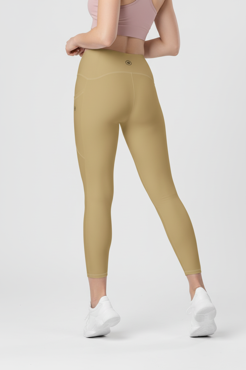 Person wearing beige leggings and white sneakers on a light gray background