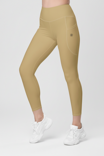 Beige leggings worn by a person on a white background