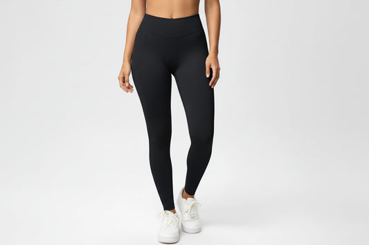 Person wearing black leggings on a white background