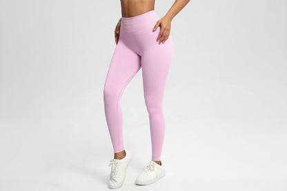 Person wearing pink leggings on a white background