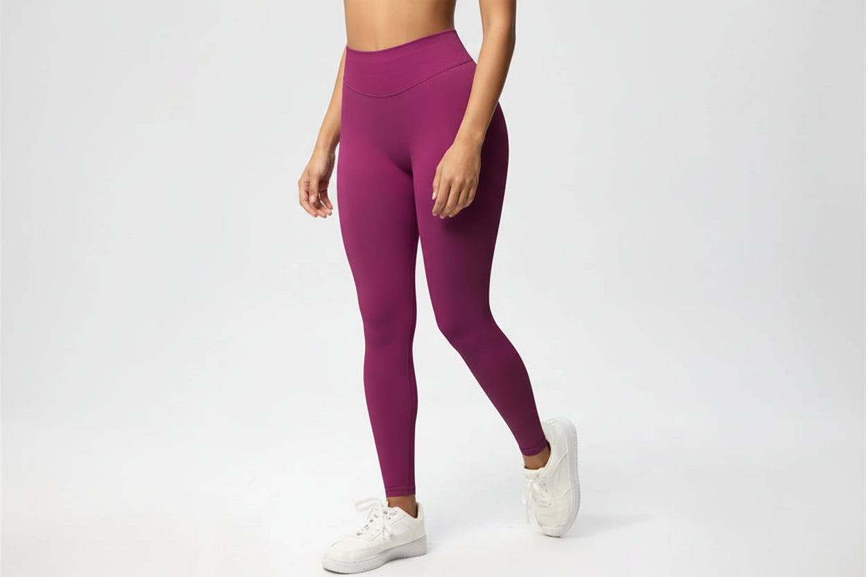 Person wearing purple leggings on a white background