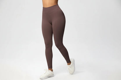 Brown leggings worn by a person on a white background
