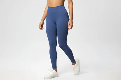 Person wearing blue leggings on a white background
