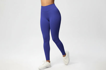 Person wearing blue leggings on a white background