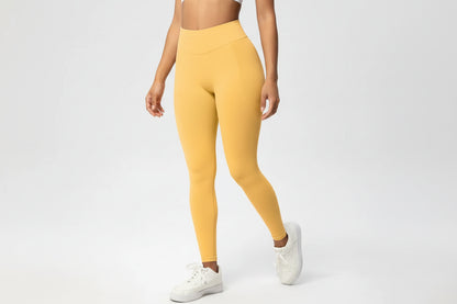 Person wearing yellow leggings on a white background
