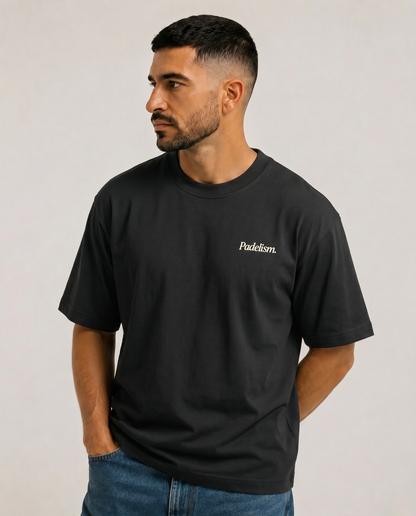 Black heavyweight t-shirt with small chest “Padelism.” logo on model