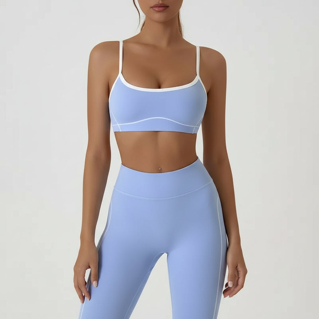 Person wearing a light blue sports bra and leggings set on a plain background