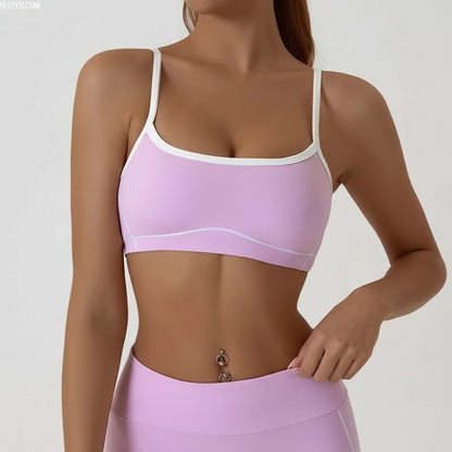Person wearing a pink sports bra and leggings on a plain background