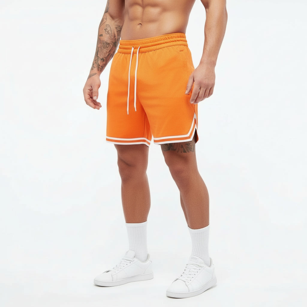 Person wearing bright orange shorts with white drawstring and trim on a white background