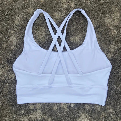 White padded cross-back sports bra with crisscross back straps and scooped neckline