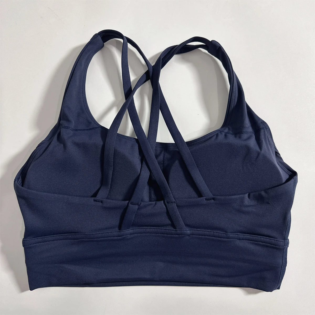 Navy cross-back padded sports bra with wide band and crisscross back straps