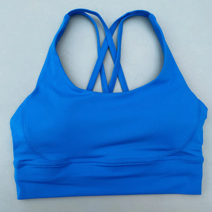 Bright blue padded sports bra with crisscross cross-back straps and smooth underband.