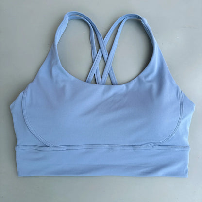 Light blue cross-back padded sports bra with crossed open-back straps