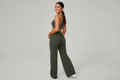 Person wearing olive green wide-leg pants on a gray background