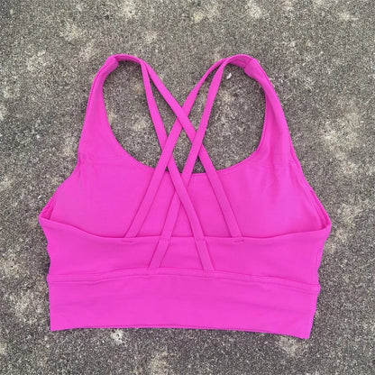 Hot pink padded cross-back sports bra with crisscross back straps and wide underband