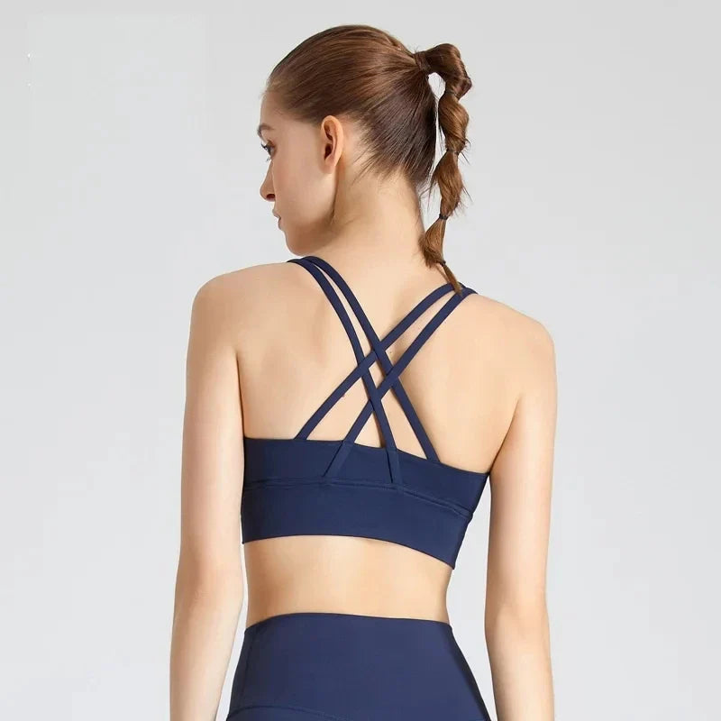 Navy padded cross-back sports bra, back view with crisscross shoulder straps