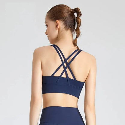 Navy padded cross-back sports bra, back view with crisscross shoulder straps