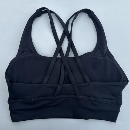 Women's cross-back padded sports bra in dark navy with crisscross back straps and band.