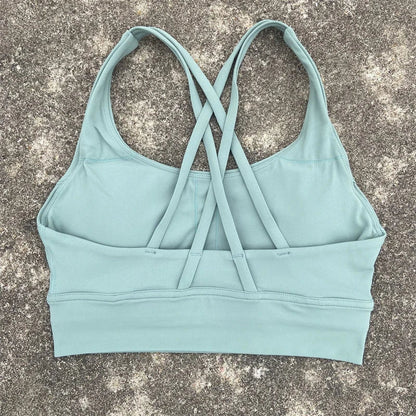 Women's padded cross-back sports bra in mint green with crisscross back straps