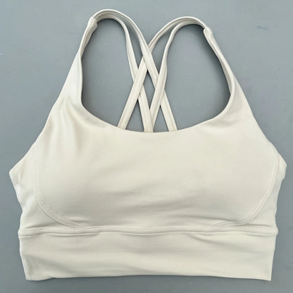 Women's cross-back padded sports bra in white with crisscross straps at back neckline.