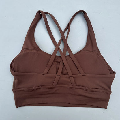 Women's cross-back padded sports bra in brown with crisscross back straps and wide band.