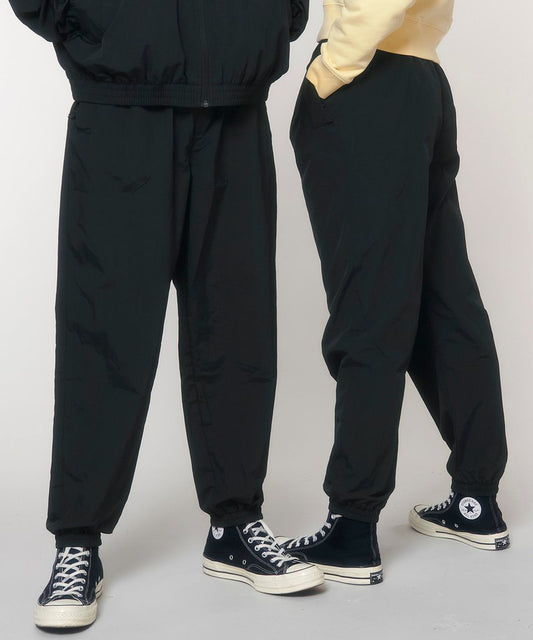 Recycled nylon tracksuit pants in black, elastic waistband and cuffs, drawstring.