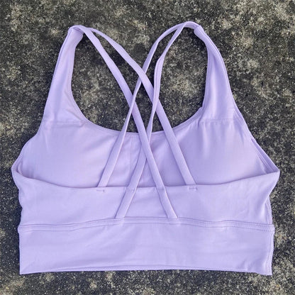 Women's padded cross-back sports bra in light purple with crisscross back straps