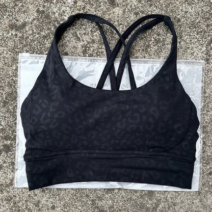 Black padded cross-back sports bra with crisscross back straps and smooth band