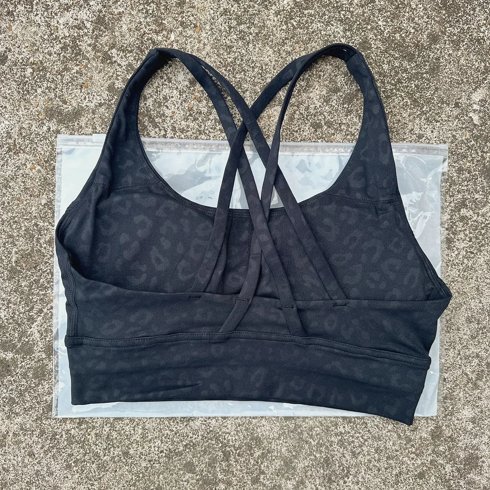 Dark navy padded sports bra with crisscross cross-back straps and wide underband.