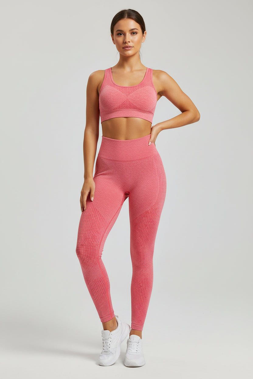 Woman wearing a pink athletic outfit on a light gray background