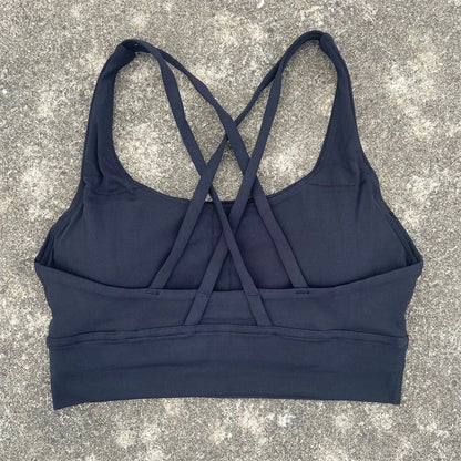Women's padded cross-back sports bra in dark navy with crisscross back straps