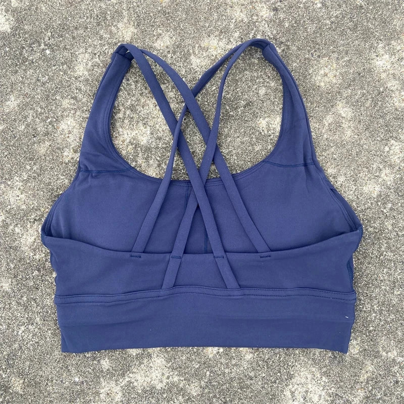 Women's padded cross-back sports bra in navy blue with crisscross back straps