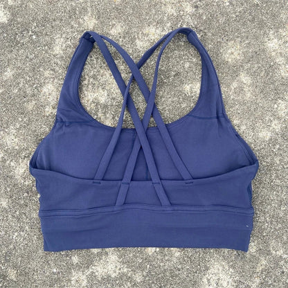 Women's padded cross-back sports bra in navy blue with crisscross back straps