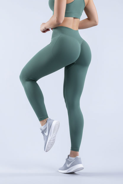 Green leggings worn by a person on a light gray background
