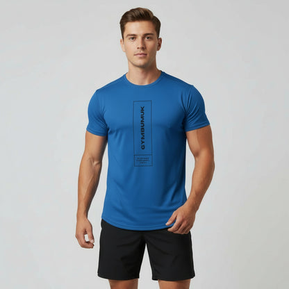 Man wearing a blue t-shirt with a logo on a gray background