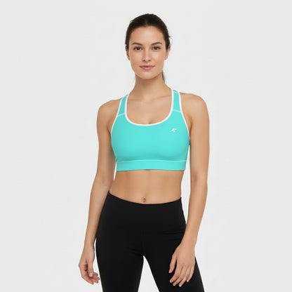 Woman wearing a turquoise sports bra and black leggings on a white background