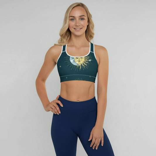 Woman wearing a sports bra and leggings with a celestial design on a plain background