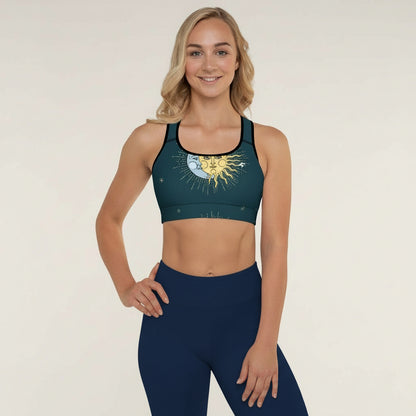 Woman wearing a green sports bra with a sun design and matching leggings on a beige background